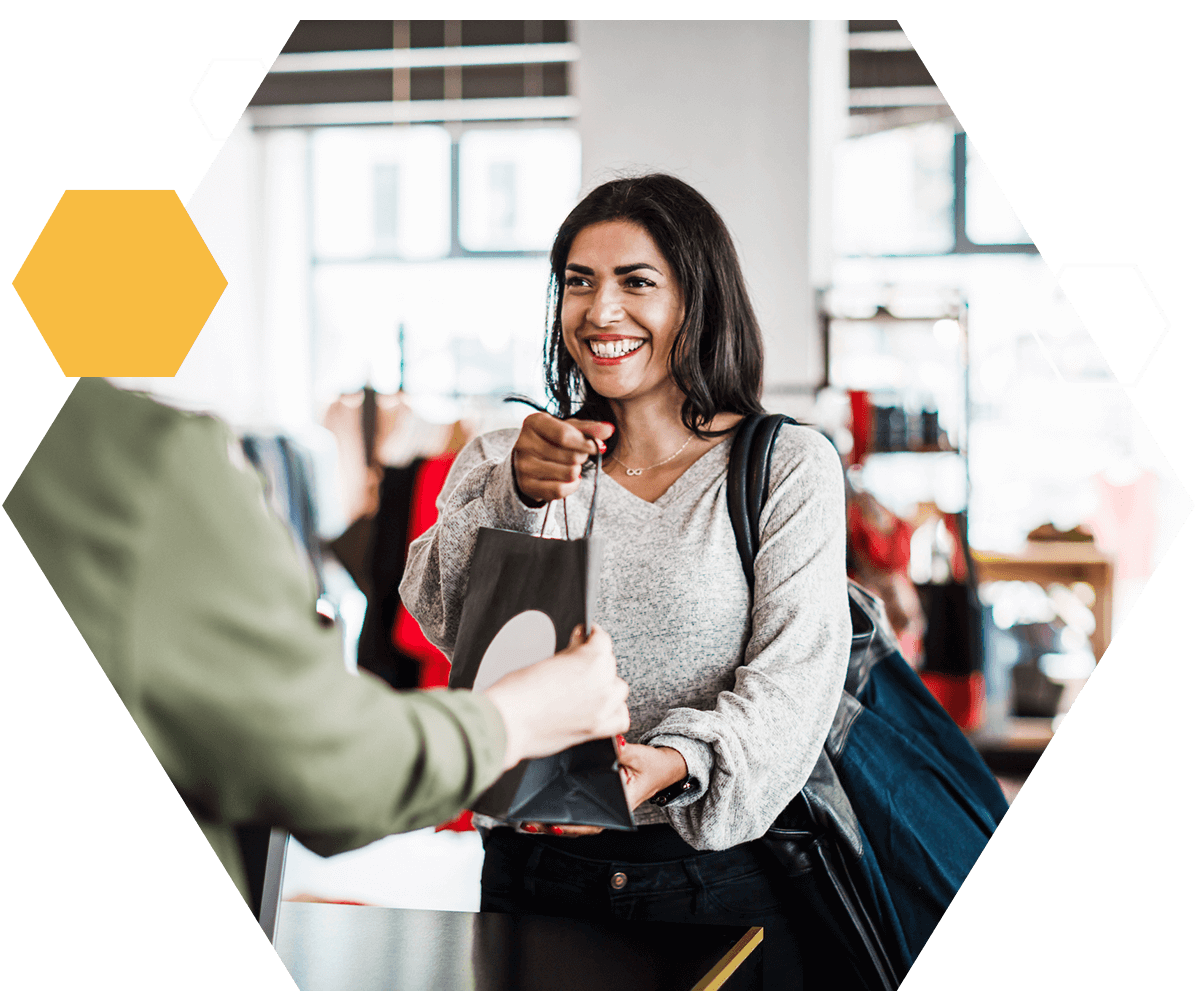 Woman making an in store purchase looking happy