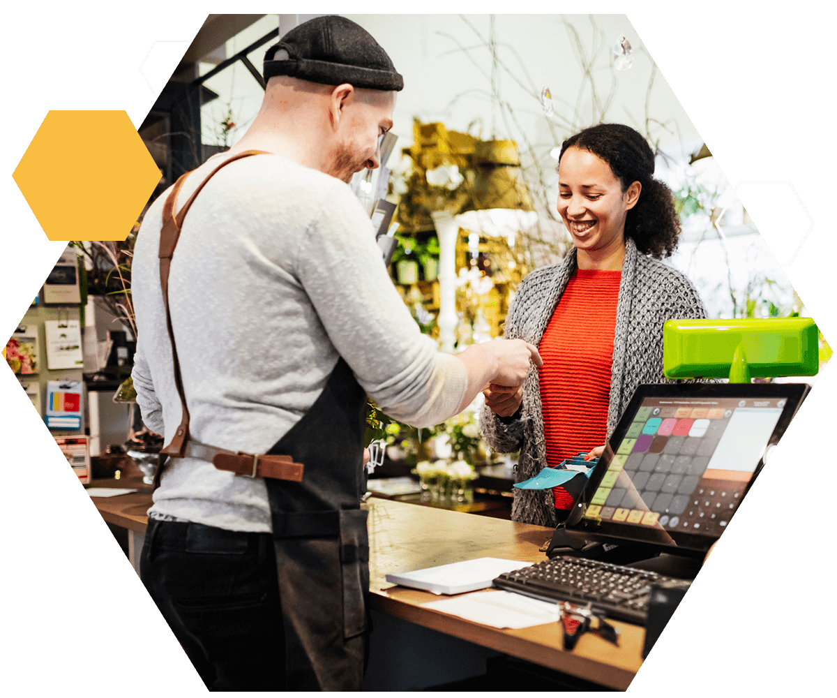 Florist Serving Customer At Cash Register