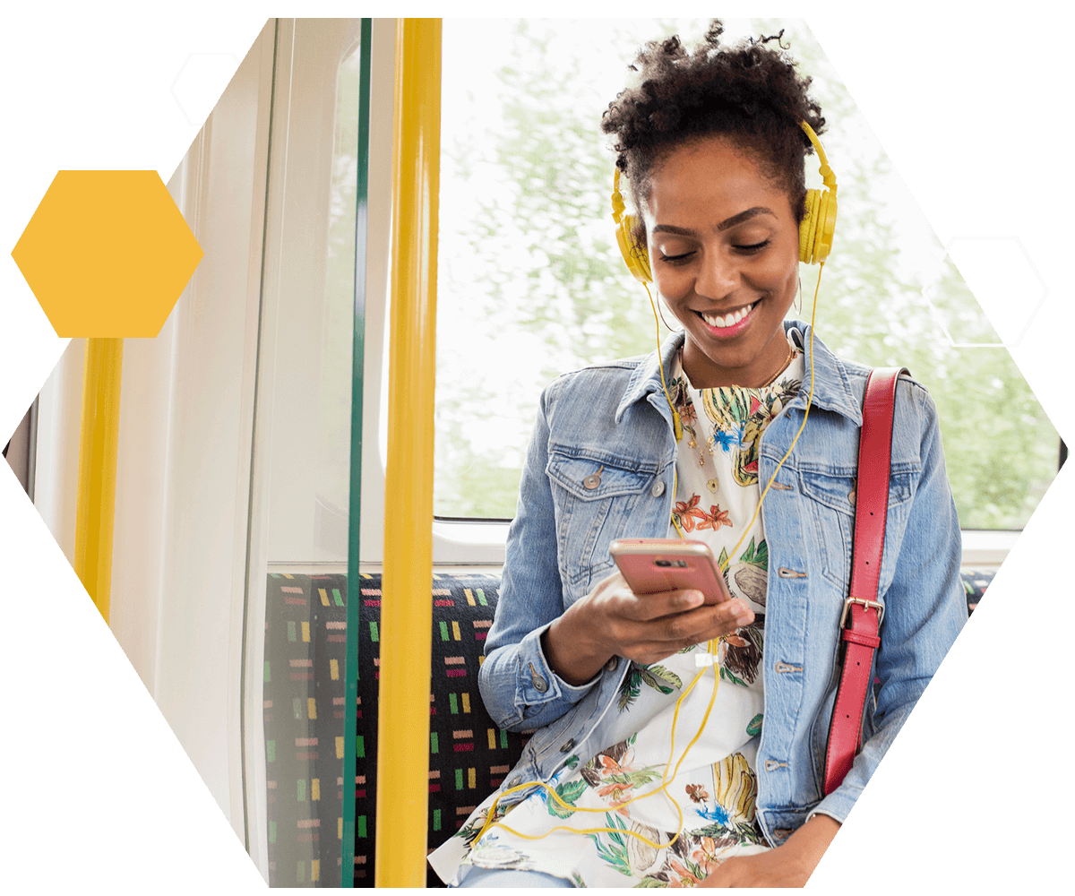 Woman on train looking at her phone happy