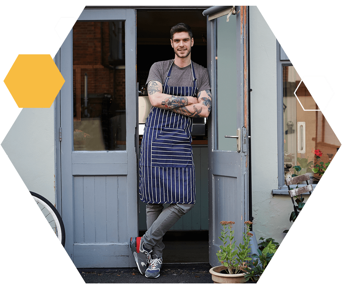 Local cafe owner standing outsider of shop