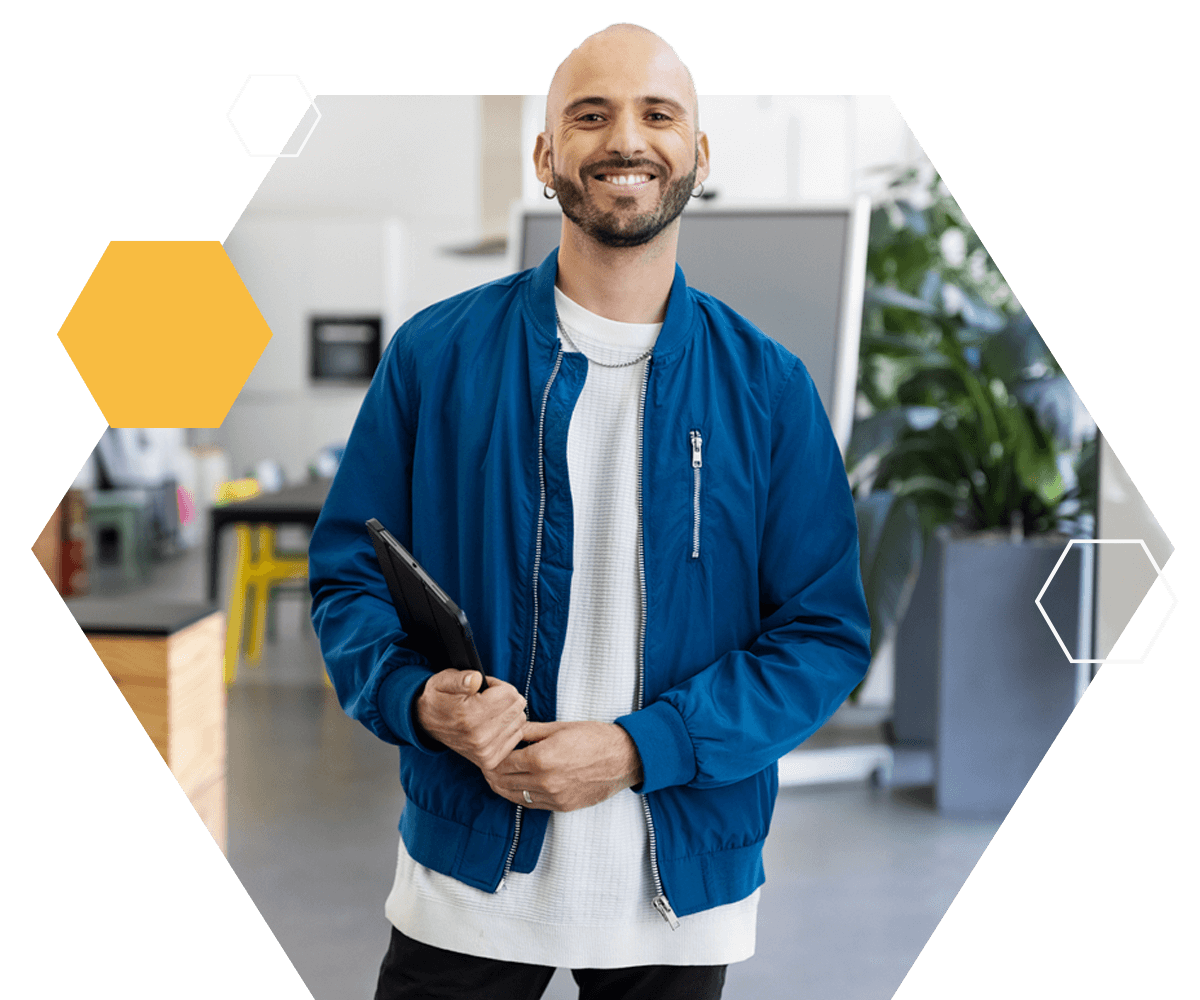 Business man holding a tablet device smiling